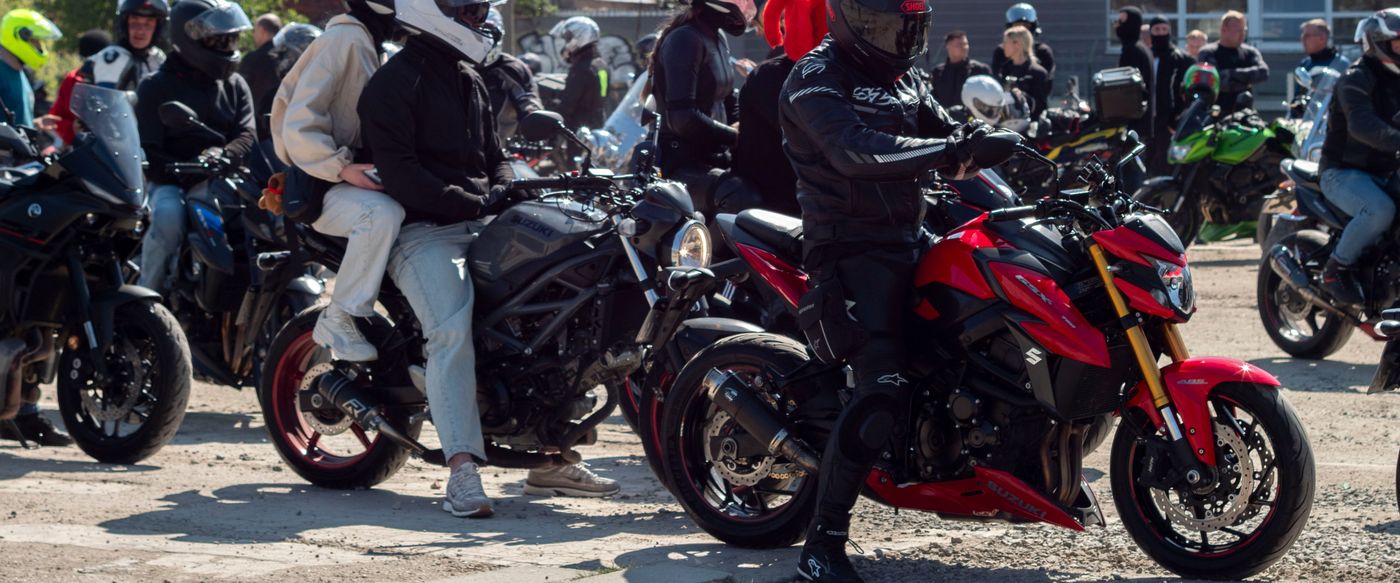 A large group of riders and their motorcycles gathered together.